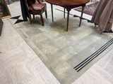 two chairs and a table in a room with a rug on the floor