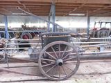 a horse pulling a cart inside of a barn