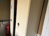 a chair in the corner of a room next to a closet