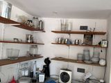 a small kitchen with a sink and a lot of shelves