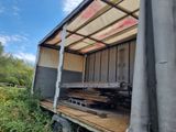 a truck that has a lot of wood on the back of it