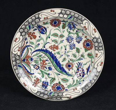 a close up of a plate with flowers and leaves on it