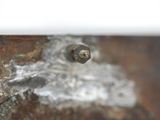 a close up of a bolt on a piece of metal