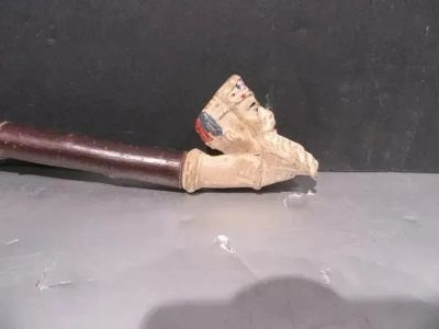 a pipe that is sitting on a table next to a black wall