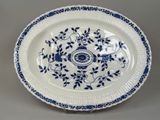 a blue and white plate with a floral design on it