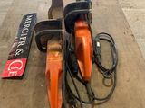 two chainsaws that are sitting on a table