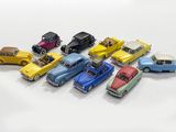 several toy cars are lined up in a row on a white surface