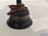 a small bell with a rope on top of it