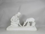 white statue of a woman and a dog on a white surface