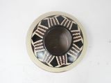 a black and white bowl with a design on it