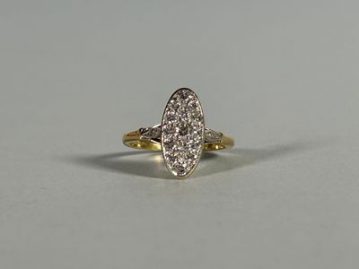 a gold and diamond ring on a white surface