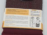 a close up of a red towel with a label on it