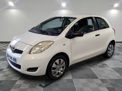 la petite voiture blanche est garée sur un carrelage à carreaux