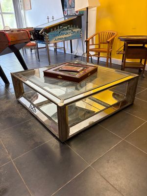 a coffee table with a glass top in the middle of a room