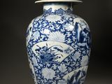 a blue and white vase with a lid sitting on a table