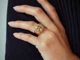 someone is wearing a ring with a diamond on it and a black shirt