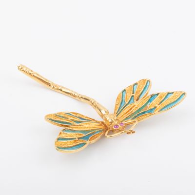 an image of a gold dragonfly brooch with turquoise and pink stones