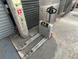 an image of a forklift in front of a garage door