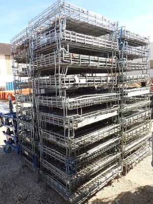 a large pile of metal scaffolding in a parking lot