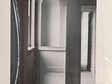 a black and white photo of a kitchen with a refrigerator