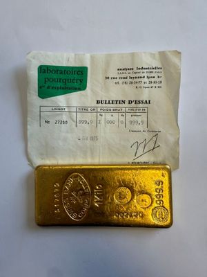 un gros plan d'un morceau d'or posé sur une feuille de papier