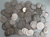 a pile of silver coins on a table
