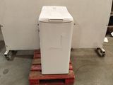 a white refrigerator sitting on a pallet in a warehouse