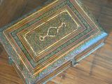 a wooden box with a design on it on a table