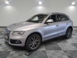 the silver audi suv is parked on a checkered tile floor