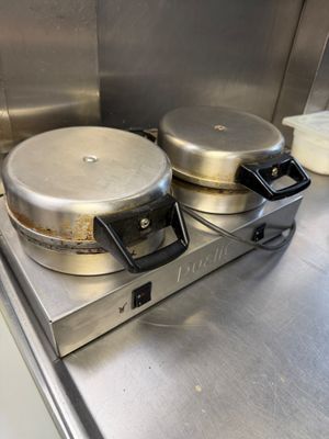 stainless steel counter top with two pans on top of it