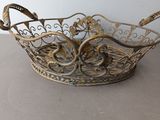 a metal basket with a handle on a table