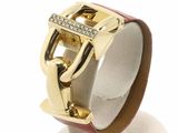 a gold ring with a buckle and diamonds on it