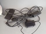 a pile of electrical cords and a charger on a table