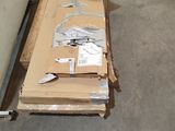 a pile of cardboard sitting on the floor next to a wall