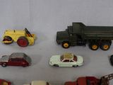 many different toy cars and trucks on a white surface