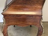 a small wooden table with a suitcase on top of it