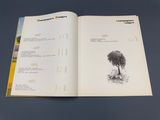 an open book with a drawing of a tree on it