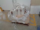 four rolls of toilet paper wrapped in plastic on a carton