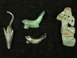 several pieces of ancient artifacts are displayed on a black surface