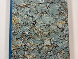 blue and gold marbled notebook with a blue cover