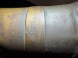 a close up of a piece of metal with a tape on it