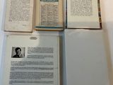 three open books sitting on top of a white table next to each other
