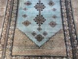 a blue rug on the floor in a room