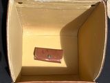 an open box that has a small piece of leather in it