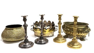 four different types of brass candlesticks and a bowl