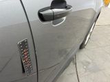 a close up of a car door handle with a sticker on it