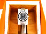 a watch in a box that is open on the table