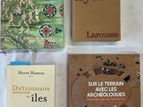 several books are laid out on a table with a white table cloth