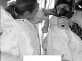 a black and white photo of two women in protective gear