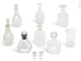 a lot of glass bottles that are sitting on a white surface